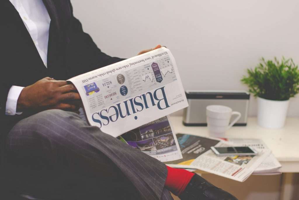 Success-ful business man reading the newspaper